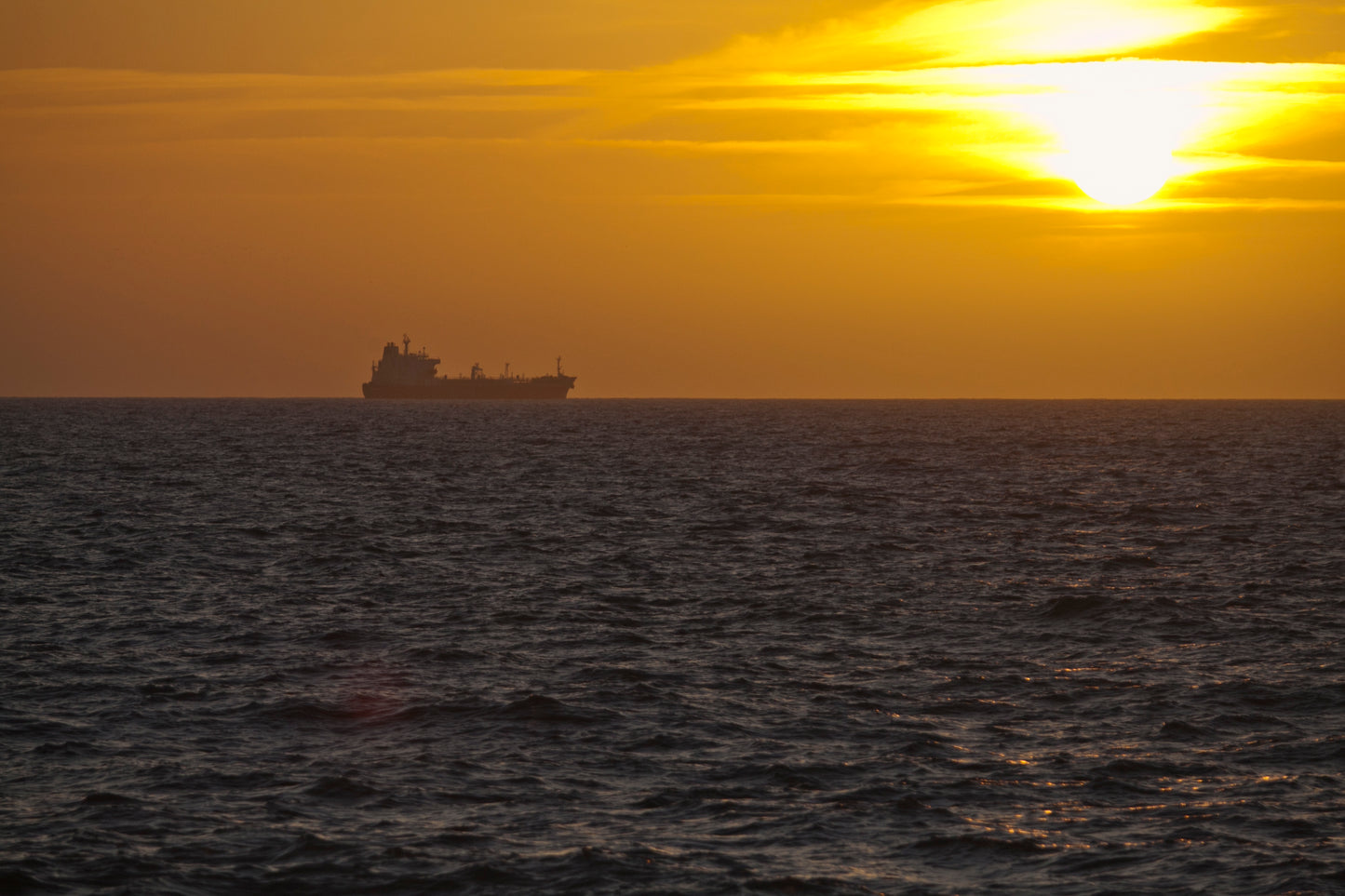 Amazing sunset in Israel Mediterranean sea with ship on the horizon