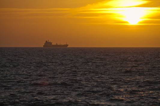 Amazing sunset in Israel Mediterranean sea with ship on the horizon